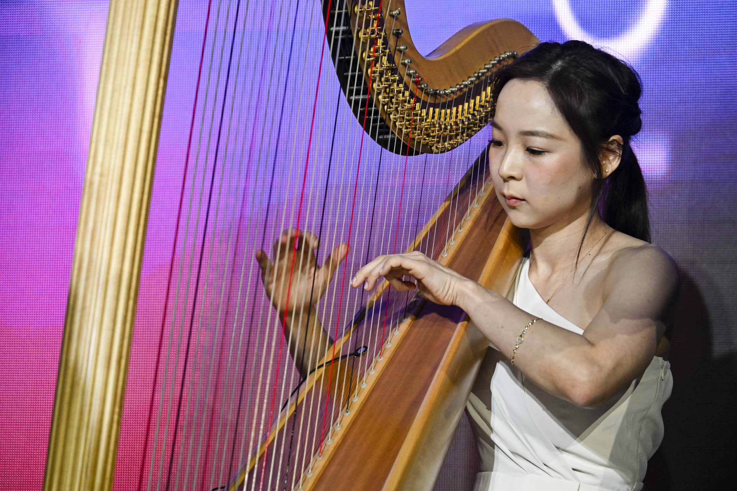 Dr Ellie Choi performing on the harp at NUHS Tribute Awards Ceremony 2025